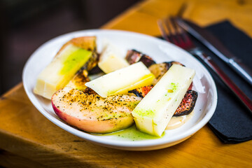 Fig & Peach appetiser of Grilled peach, grilled fig, taleggio cheese, yuzu dressing