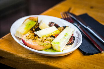 Fig & Peach appetiser of Grilled peach, grilled fig, taleggio cheese, yuzu dressing