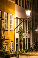 Copenhagen, Denmark A small street with parked bicycles  in the Christianshavn district at night.