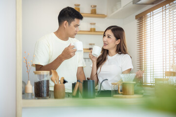 Couple, 2 people or lover to made, drink coffee together in kitchen, home in morning. Include coffee cup or mug, blind and light from window. Concept for lifestyle, love, happy, family, relationship.

