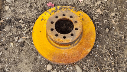 Rusty worn out car brake disc. Natural yellow rust.