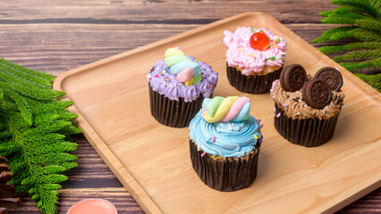 Colorful Cupcakes on wooden table  .