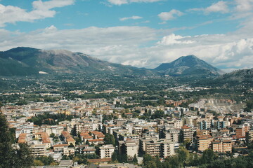 The mountain city with buildings and mountains around