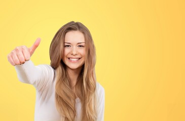 Young woman feeling happy and posing with a big smile