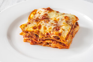 Portion of lasagne on white plate