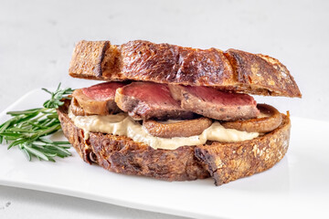 Sandwich with beef steak and mushrooms