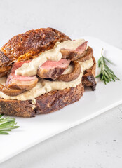Sandwich with beef steak and mushrooms