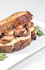 Sandwich with beef steak and mushrooms