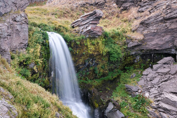 Long exposure shot of Mantash waterfall on cloudy summer day. Mount Aragats, Armenia.