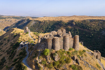 Fototapeta premium Drone view of Amberd fortress on Mount Aragats slope on sunny summer evening. Aragatsotn Province, Armenia.