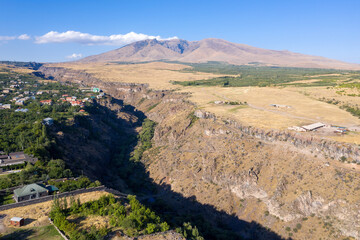 Fototapeta na wymiar Aerial view of Kasakh river gorge and Mount Ara on sunny summer day. Ohanavan village, Armenia.