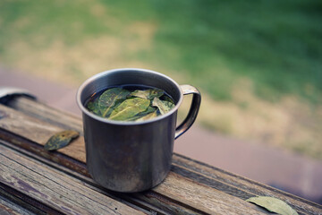 Cup of coca tea (mate de coca) on a bank