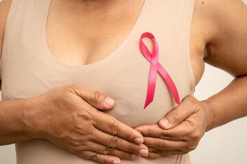 Breast cancer, pink ribbon at Asian senior lady for supporting awareness, symbol of World Breast...