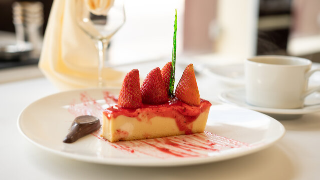 Beautifully served dessert food on a plate. Cheesecake with strawberry
