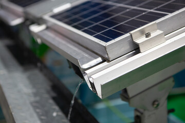 Close-up of Photovoltaic panel system installation with rain gutter. Solar cell panel.