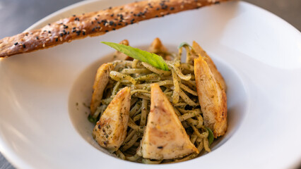 Beautiful served spaghetti pasta with chicken on plate. With natural vegetables. 