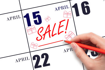 Hand writing text SALE and drawing gift boxes on calendar date April 15. Shopping Reminder