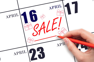 Hand writing text SALE and drawing gift boxes on calendar date April 16. Shopping Reminder