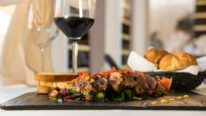 beef with vegetables, sauce, and bread. mexican dish arrachera. black background