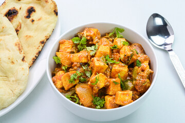 Kadai Paneer indian dish served with naan