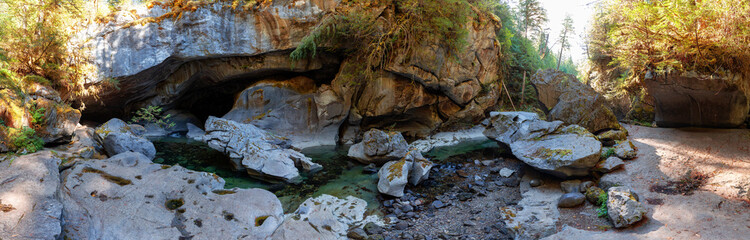 Cave and river in a canyon. Canadian Nature Background. Panorama. Little Huson Caves Park, Vancouver Island, British Columbia, Canada.