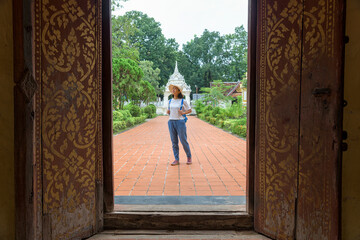 Young woman walking in Wat Si Saket is a Buddhist wat at Vientiane, Laos. Lao Travel Concept