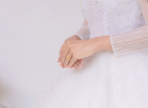 The Hand Of The Woman Or Bride Wearing A Gold Ring.