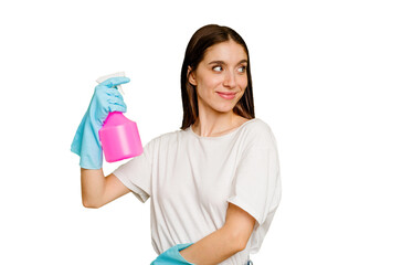 Young cleaner woman isolated looks aside smiling, cheerful and pleasant.