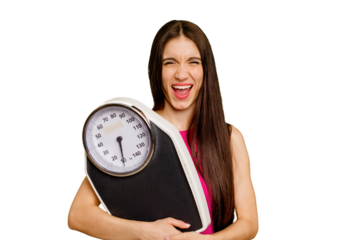 Young caucasian woman holding a scale isolated screaming very angry and aggressive.
