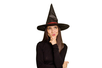 Young caucasian woman dressed as a witch for halloween day isolated looking sideways with doubtful and skeptical expression.