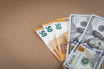 Paper money banknotes dollars and euros on a brown background with a vintage paper texture. Close up. Copy Space. Grunge