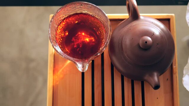 View from above. Chinese tea ceremony. Pu erh tea in a glass bowl. 4k. Slow Motion