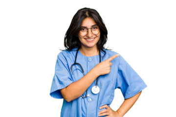 Young nurse Indian woman isolated smiling and pointing aside, showing something at blank space.