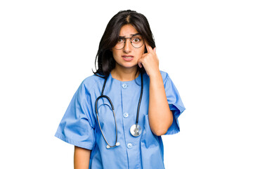 Young nurse Indian woman isolated showing a disappointment gesture with forefinger.