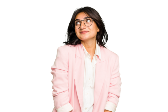 Young Indian business woman wearing a pink suit isolated dreaming of achieving goals and purposes