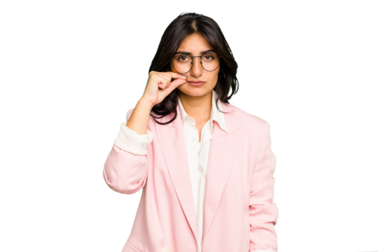 Young Indian business woman wearing a pink suit isolated with fingers on lips keeping a secret.