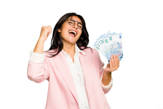Young business Indian woman holding banknotes isolated raising fist after a victory, winner concept.