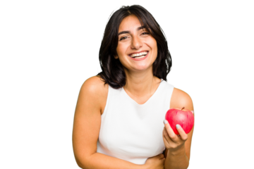 Young Indian woman holding an apple, healthy lifestyle, isolated laughing and having fun.
