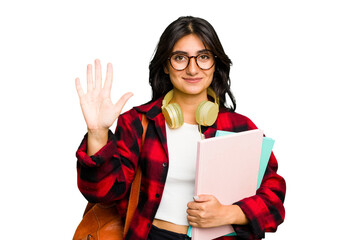 Young student Indian woman wearing headphones isolated smiling cheerful showing number five with...