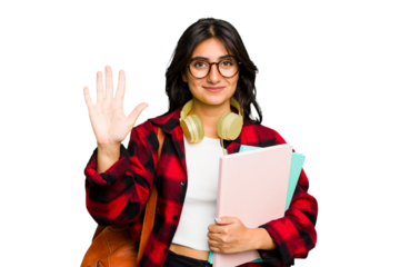 Young student Indian woman wearing headphones isolated smiling cheerful showing number five with fingers.