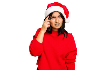 Young Indian woman celebrating Christmas wearing a santa hat isolated showing a disappointment gesture with forefinger.