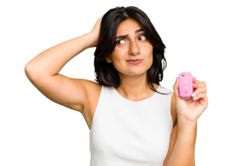 Young Indian woman holding a car keys isolated touching back of head, thinking and making a choice.