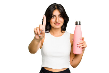 Young Indian woman holding a thermo isolated showing number one with finger.