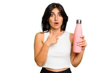 Young Indian woman holding a thermo isolated pointing to the side