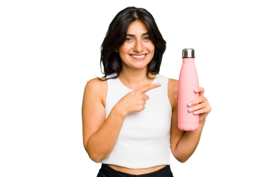 Young Indian woman holding a thermo isolated smiling and pointing aside, showing something at blank space.