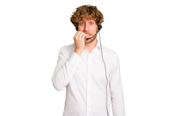 Telemarketer man working with a headset isolated on green chroma background biting fingernails, nervous and very anxious.