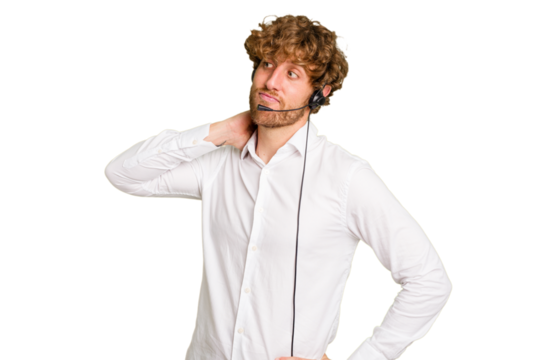 Telemarketer man working with a headset isolated on green chroma background touching back of head, thinking and making a choice.