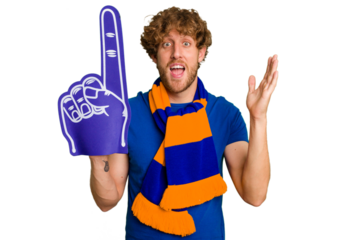 Young caucasian sports fan man isolated on white background receiving a pleasant surprise, excited and raising hands.