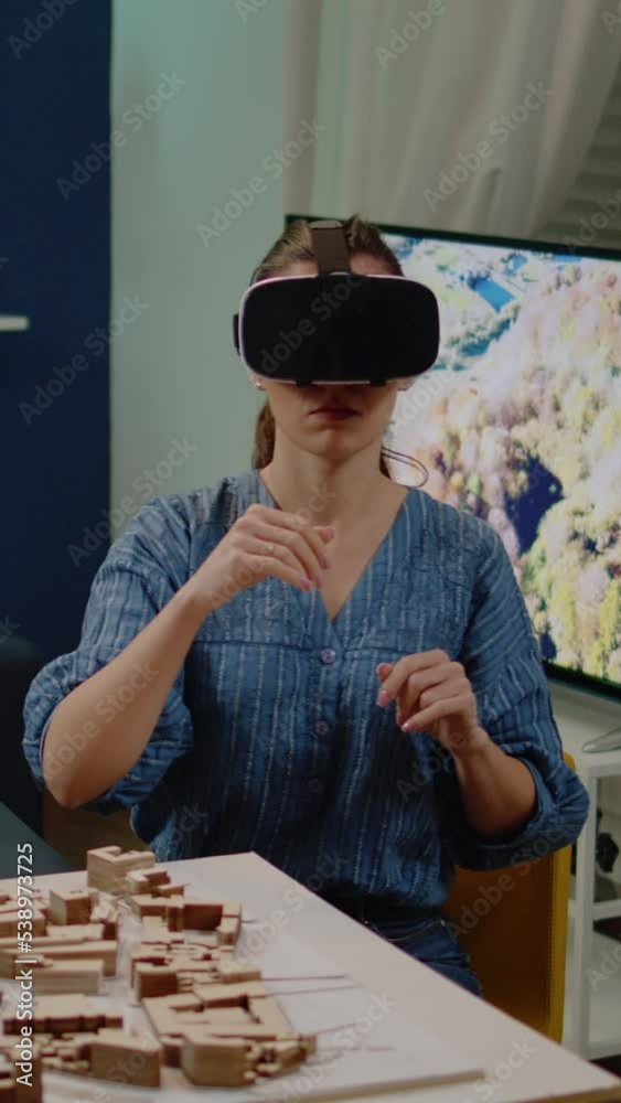 Poster vertical video: architect using vr glasses for building design with blueprint plan on table. constru