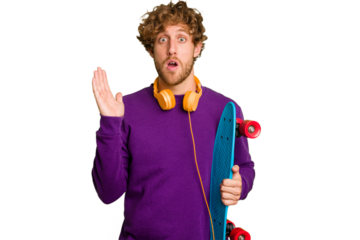 Young skater caucasian man isolated on white background surprised and shocked.